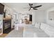Open-concept living room with a fireplace, flows into the kitchen and dining area at 10885 Longs Peak Ln, Parker, CO 80138