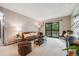 Inviting living room with comfortable seating, a modern entertainment center, and balcony access at 7770 W 38Th Ave # 207, Wheat Ridge, CO 80033