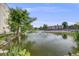 Relax by the scenic community pond featuring a fountain, lush greenery, and tranquil views at 7770 W 38Th Ave # 207, Wheat Ridge, CO 80033