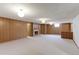 Expansive basement featuring a fireplace, wood paneled walls and neutral carpet at 3375 Zephyr Ct, Wheat Ridge, CO 80033