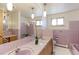 Bathroom featuring double sinks, large mirror and pale pink tile at 3375 Zephyr Ct, Wheat Ridge, CO 80033