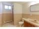 Small bathroom with single sink, shower and unique tile work at 3375 Zephyr Ct, Wheat Ridge, CO 80033