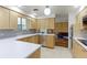Modern kitchen featuring light wood cabinets, white countertops, stainless steel appliances, and tile floors at 3375 Zephyr Ct, Wheat Ridge, CO 80033
