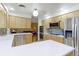 Open-concept kitchen with stainless steel appliances, adjacent living area, and ample counter space at 3375 Zephyr Ct, Wheat Ridge, CO 80033