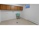 Convenient laundry room features tile flooring, storage cabinets, and utility sink at 3375 Zephyr Ct, Wheat Ridge, CO 80033