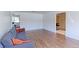 Spacious living room with hardwood floors, gray couch, and an open layout to other rooms at 3375 Zephyr Ct, Wheat Ridge, CO 80033