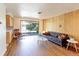 Bright living room features hardwood floors, wood accent wall and sliding doors to the backyard at 3375 Zephyr Ct, Wheat Ridge, CO 80033