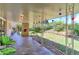Cozy covered patio features a brick fireplace and views of the landscaped backyard at 3375 Zephyr Ct, Wheat Ridge, CO 80033