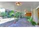 Spacious covered patio features a seating area and tranquil view of the backyard at 3375 Zephyr Ct, Wheat Ridge, CO 80033