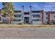 Exterior of the building with balconies, neutral paint, and well-manicured landscaping providing curb appeal at 14467 E 1St Dr # A04, Aurora, CO 80011
