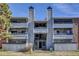 Detailed shot of the building featuring balconies, a stairwell entrance, and manicured lawn at 14467 E 1St Dr # A04, Aurora, CO 80011