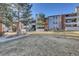 Beautiful condo building with a well-kept lawn, inviting facade, balconies, and staircase at 14467 E 1St Dr # A04, Aurora, CO 80011