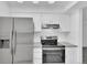 Modern kitchen featuring stainless steel appliances, white cabinets, and gray countertops at 14467 E 1St Dr # A04, Aurora, CO 80011