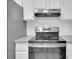 Kitchen featuring stainless steel appliances, white cabinets, and gray countertops at 14467 E 1St Dr # A04, Aurora, CO 80011