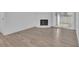 Bright living space with wood-look floors, a cozy fireplace, and access to a patio at 14467 E 1St Dr # A04, Aurora, CO 80011
