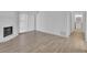 Bright living room with fireplace and light wood-look floors, and patio access at 14467 E 1St Dr # A04, Aurora, CO 80011