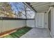 Private patio area with artificial turf, siding, and a door at 14467 E 1St Dr # A04, Aurora, CO 80011