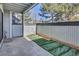 Enclosed patio features privacy fence, concrete floors, and artificial turf at 14467 E 1St Dr # A04, Aurora, CO 80011