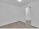 A simple, bright room with wood-style flooring, and view into the hallway at 14467 E 1St Dr # A04, Aurora, CO 80011