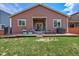 Backyard with patio, grill, swing chairs, and well-maintained lawn, ideal for outdoor activities and entertaining at 675 W 171St Pl, Broomfield, CO 80023