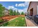 Lush backyard featuring a wooden fence, garden area, patio, and well-kept lawn, perfect for outdoor enjoyment and gardening at 675 W 171St Pl, Broomfield, CO 80023