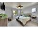 A cozy bedroom featuring a ceiling fan, soft carpet, neutral walls, and a comfortable bed at 675 W 171St Pl, Broomfield, CO 80023