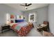 The primary bedroom has a ceiling fan, wall art, and large window for natural lighting at 675 W 171St Pl, Broomfield, CO 80023
