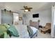 The bedroom includes a sliding barn door, a bathroom entrance, and a ceiling fan for added comfort at 675 W 171St Pl, Broomfield, CO 80023