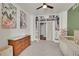 A bedroom includes shelving, a ceiling fan, modern crib, and ample space at 675 W 171St Pl, Broomfield, CO 80023