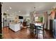 Open-concept kitchen and dining area with modern lighting and hardwood flooring at 675 W 171St Pl, Broomfield, CO 80023