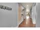 Long hallway with contemporary decor, wooden floors, and a view into the dining area at 675 W 171St Pl, Broomfield, CO 80023