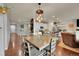 Open-concept kitchen and dining area with modern lighting and wood flooring at 675 W 171St Pl, Broomfield, CO 80023