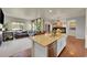 Open concept kitchen with a central island overlooking a cozy living room space at 675 W 171St Pl, Broomfield, CO 80023