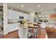 Bright kitchen featuring granite countertops, white cabinets, stainless steel appliances, and a central island at 675 W 171St Pl, Broomfield, CO 80023