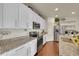 Bright kitchen with granite countertops, white cabinets, and stainless steel appliances at 675 W 171St Pl, Broomfield, CO 80023