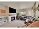 Comfortable living room with a fireplace, large sectional sofa, and a view of the outdoors at 675 W 171St Pl, Broomfield, CO 80023