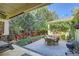 Outdoor seating area on the patio with a dining set, lush plants, charming bench, and a serene water fountain feature at 4577 Elm Ct, Denver, CO 80211