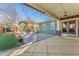 Covered patio extends living space to backyard with patterned concrete and professional landscaping at 4577 Elm Ct, Denver, CO 80211