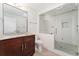 Bright bathroom with glass enclosed shower, granite topped vanity, and contemporary fixtures at 4577 Elm Ct, Denver, CO 80211