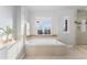 Bright bathroom featuring a soaking tub, natural light, and tiled accents at 4577 Elm Ct, Denver, CO 80211