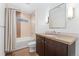 Modern bathroom featuring a shower-tub combo, a granite vanity, and tiled floors at 4577 Elm Ct, Denver, CO 80211