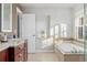 Bright bathroom featuring a soaking tub, stylish accents, and natural light at 4577 Elm Ct, Denver, CO 80211