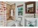 Cozy bathroom features tiled shower, chrome fixtures, and natural light from the window at 4577 Elm Ct, Denver, CO 80211