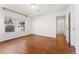 Bright bedroom featuring hardwood floors, white walls, and a large window allowing natural light at 4577 Elm Ct, Denver, CO 80211