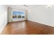 Spacious bedroom featuring large window, vaulted ceiling, hardwood flooring and abundant natural light at 4577 Elm Ct, Denver, CO 80211