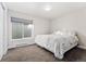 Carpeted bedroom with a queen size bed next to a window at 4577 Elm Ct, Denver, CO 80211