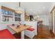 Bright dining area with a built-in bench, stylish lighting, and a view of the kitchen at 4577 Elm Ct, Denver, CO 80211