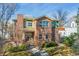 Charming two-story brick home featuring classic architectural details and a well-maintained front yard at 4577 Elm Ct, Denver, CO 80211