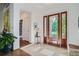 Bright foyer featuring tile flooring, a striking wooden door, and stylish decor at 4577 Elm Ct, Denver, CO 80211