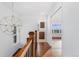 Light and airy hallway with hardwood floors and decorative chandelier at 4577 Elm Ct, Denver, CO 80211